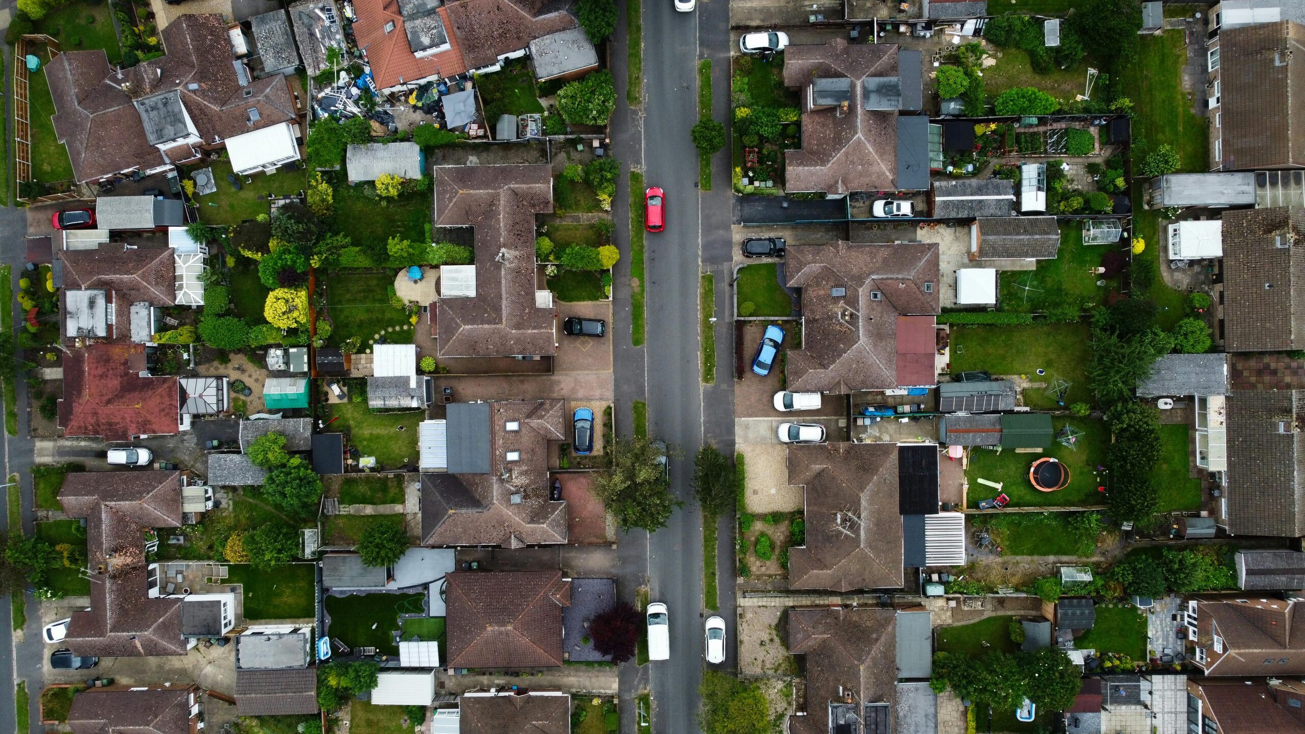 Drone shot capturing the houses and streets in a suburban area of Luton, England.